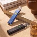 OXVA Xlim 4 in Silken Blue Leather and black on a desk beside books, lifestyle